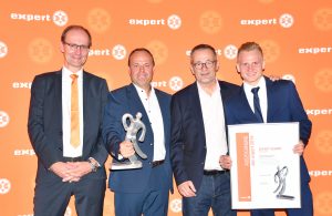 Expert-GF Alfred Kapfer und Expert International-GF Dieter Mattis gratulieren den Expert 2019 Preisträgern von Expert Scharf, Martin Scharf und seinem Sohn Maximilian.